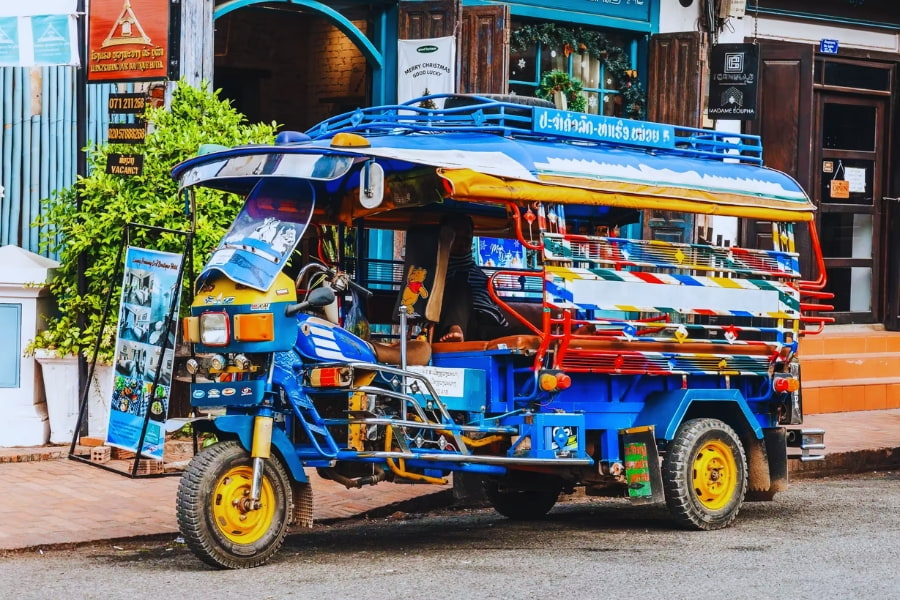 Colorful tuk tuk parked on Luang Prabang street, a popular Laos travel icon